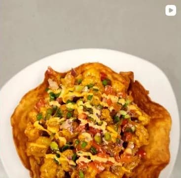 Bang Bang Shrimp piled into a crisp taco-shell bowl with pico de gallo