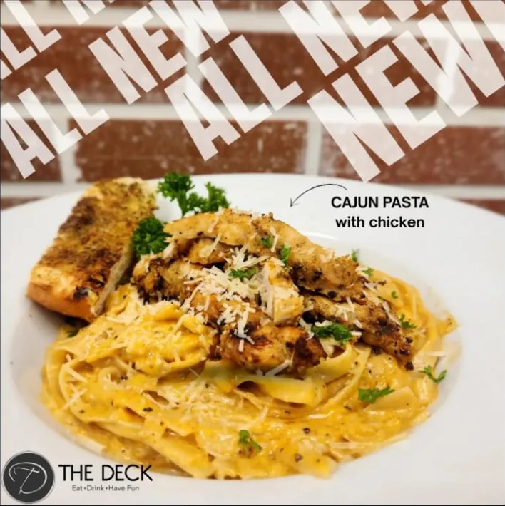 Cajun Pasta with blackened chicken in a creamy sauce and garlic bread